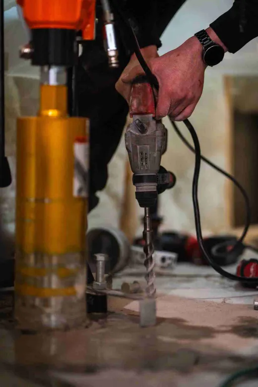 Radon mitigation drilling in progress